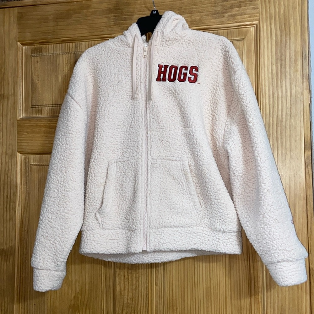 PINK fuzzy zip up jacket says “HOGS”